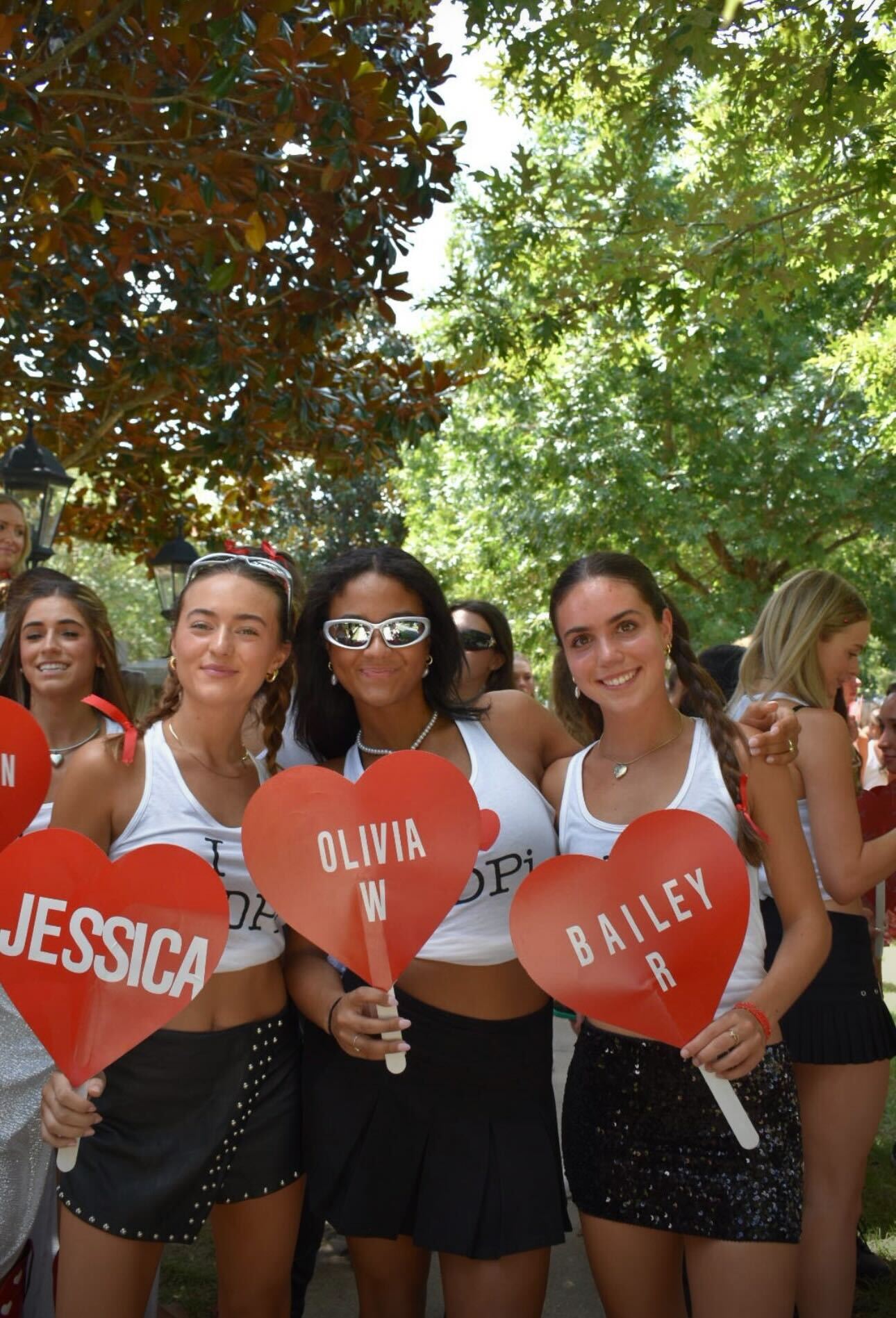 Women celebrating on bid day with heart signs